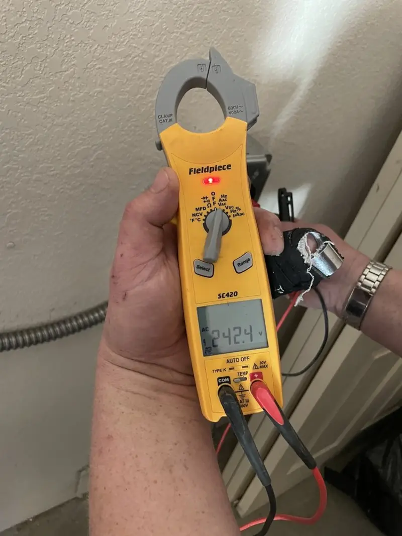 Voltage testing with clamp meter during Electrical Installation Services in Pinecrest